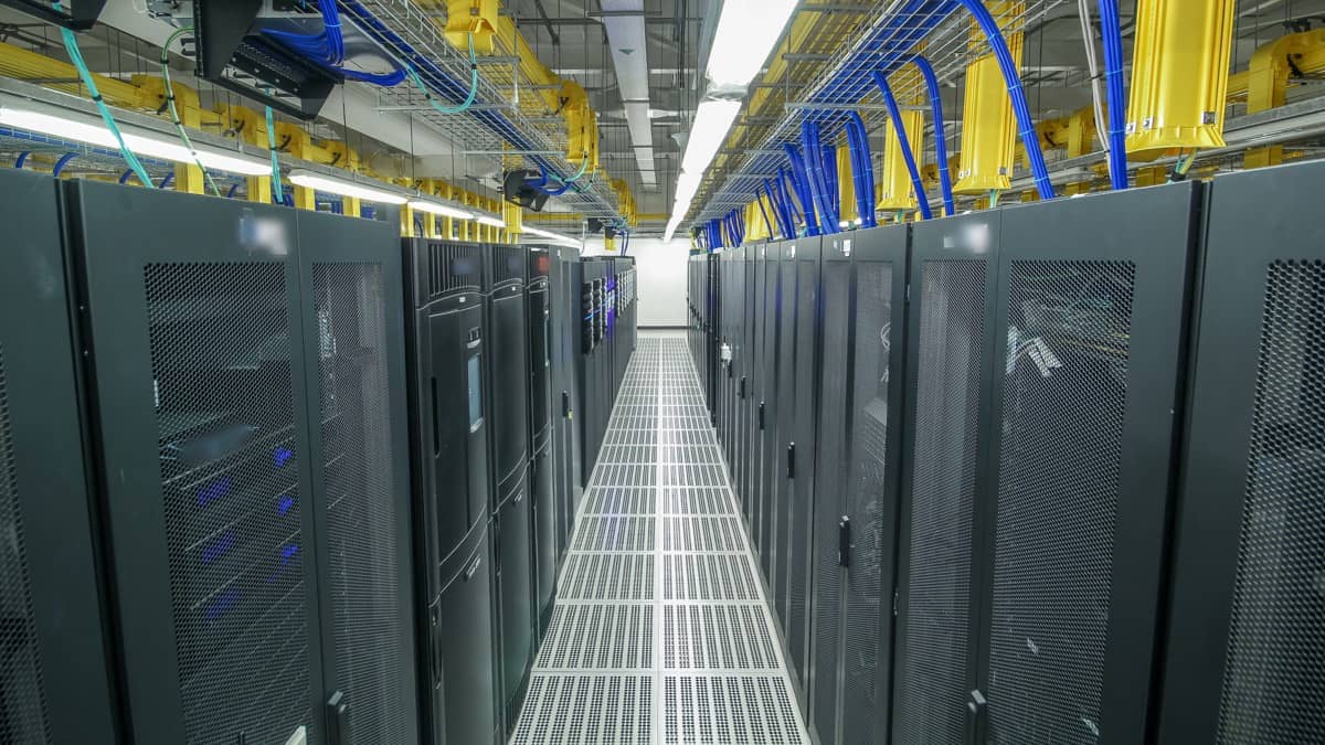 Rijen serverracks in het gangpad van een datacenter